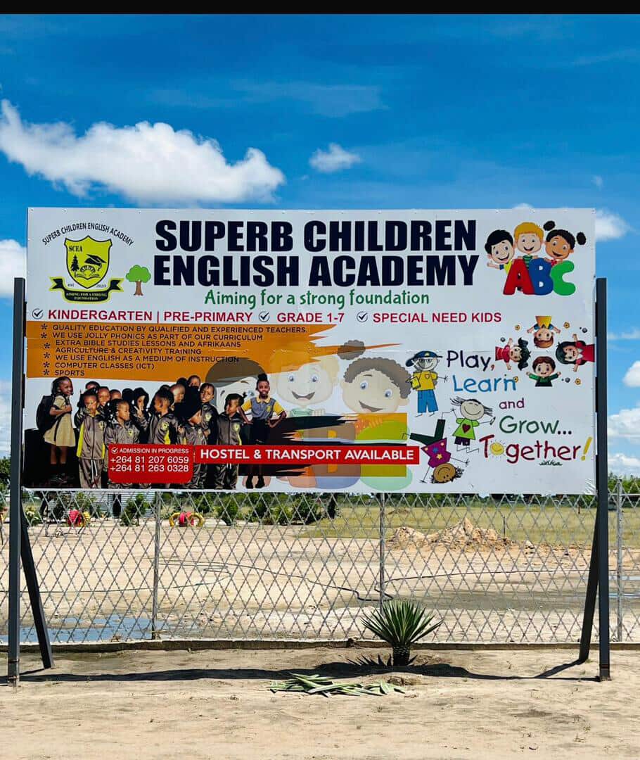 Superb Children English Academy signboard listing kindergarten to Grade 7 programmes