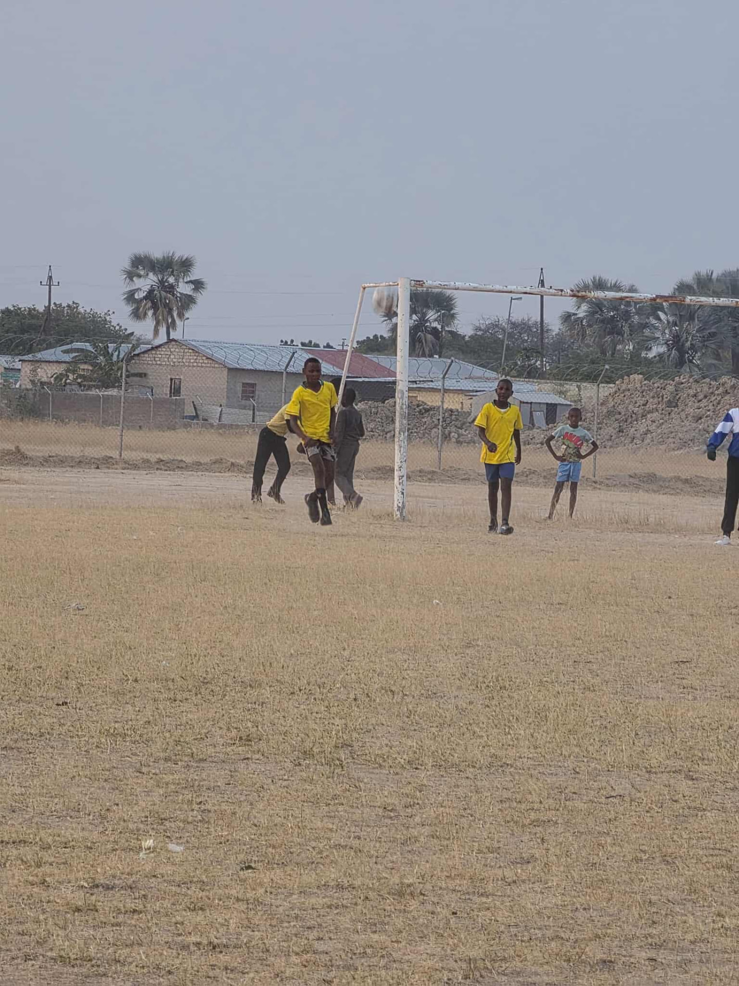 Learners playing a soccer match on the school field