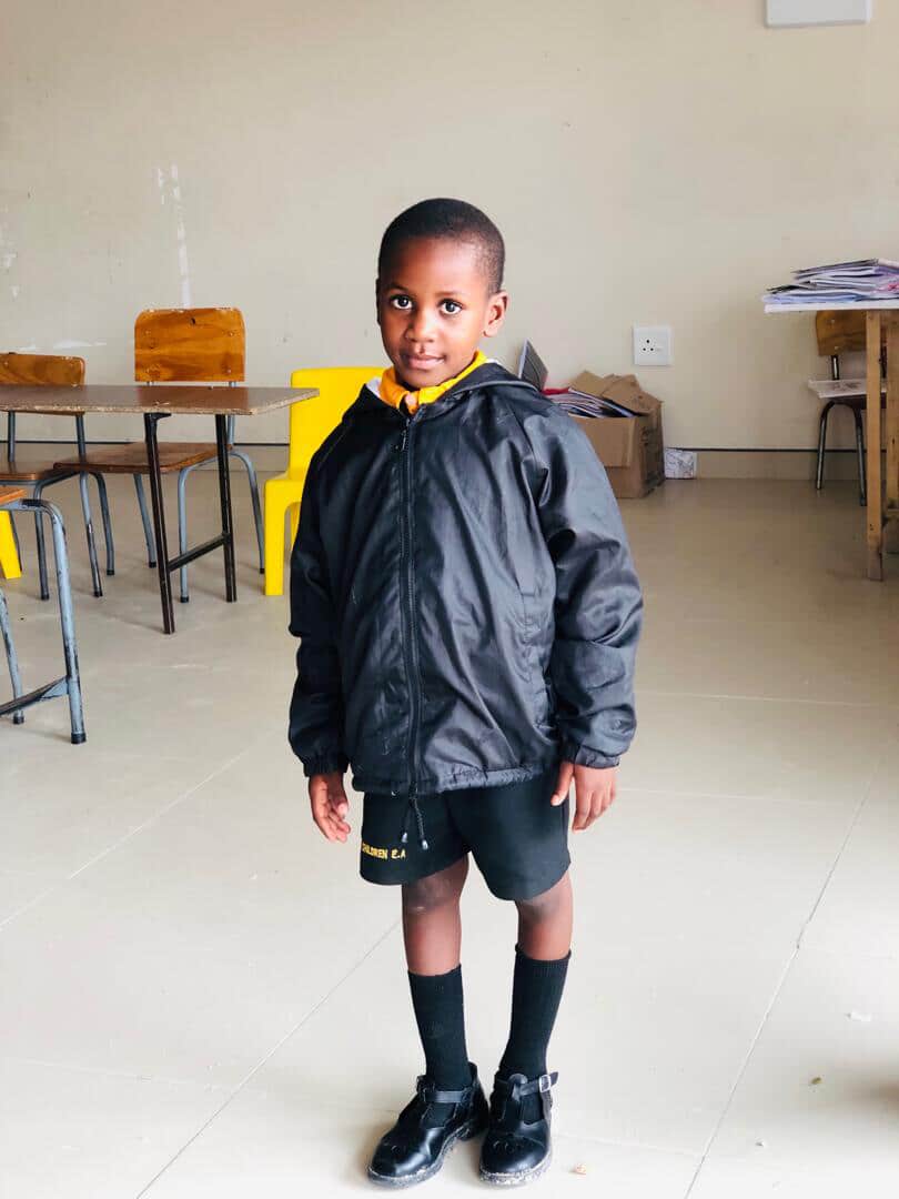 Learner in a Superb Children English Academy winter jacket standing in his classroom