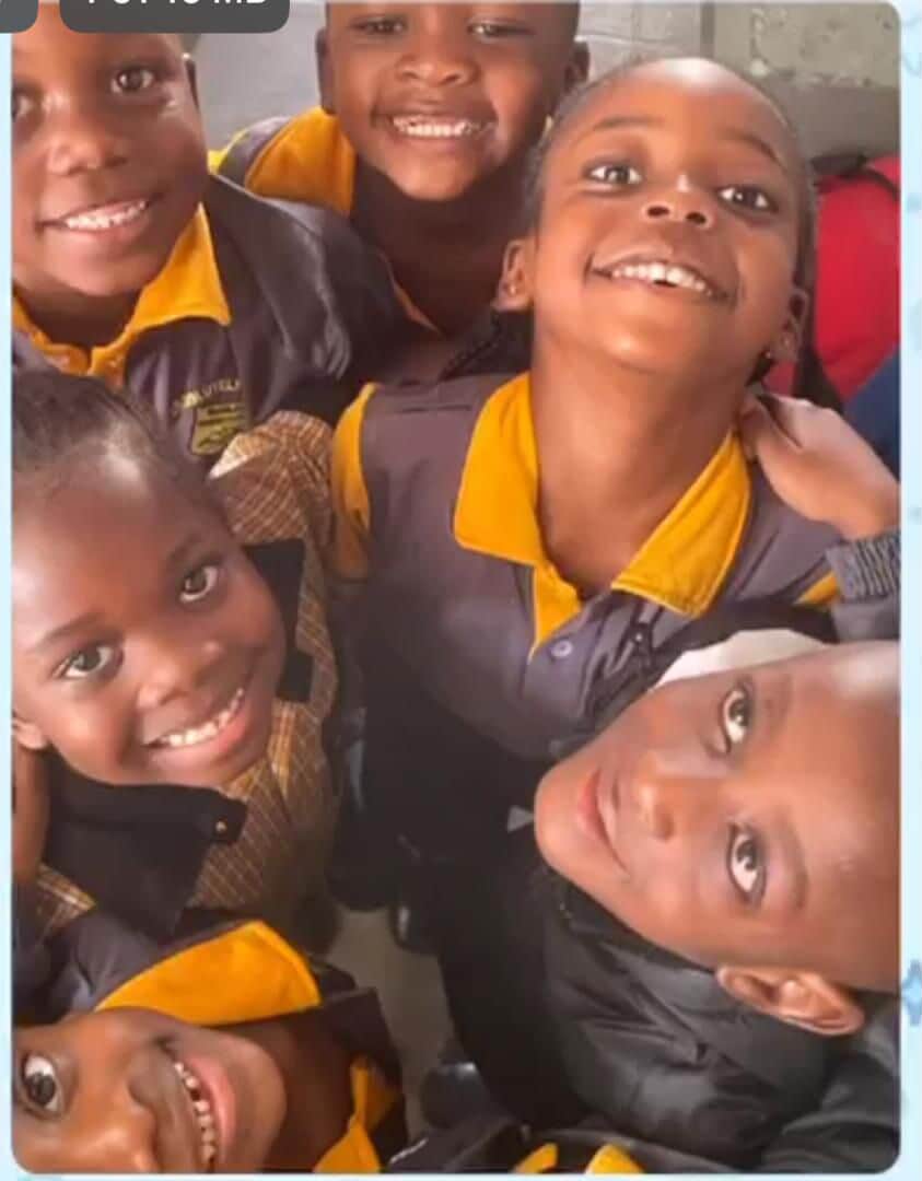 Group of smiling learners looking up at the camera