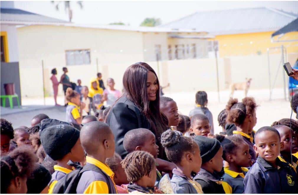 Mrs Cecilia V Kamati-Eliakim greeting a crowd of learners on the school grounds
